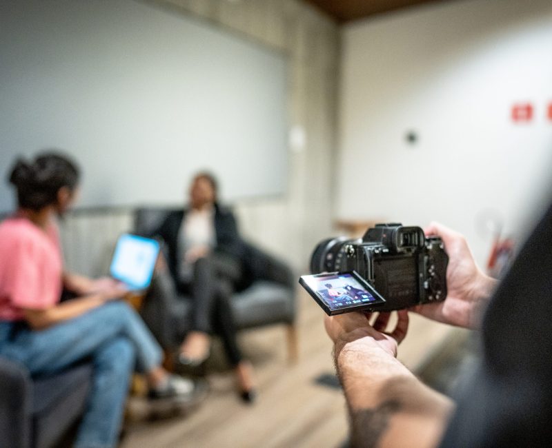 Cameraman recording video on camera